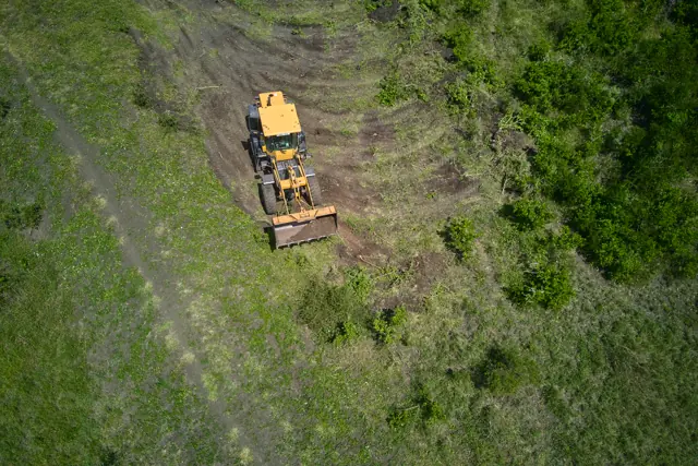 A grader cutting an internal access road at Furaha Gardens